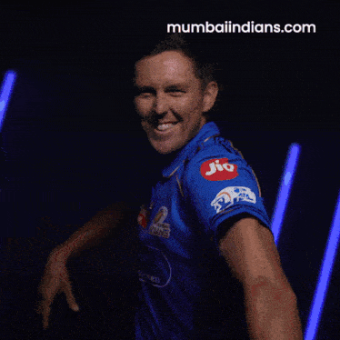 a man wearing a blue shirt with mumbai indians written on it