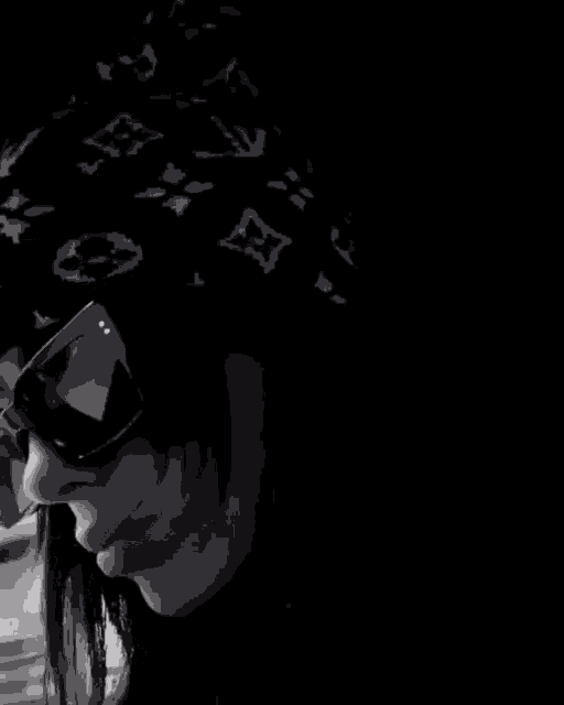 a black and white photo of a person wearing sunglasses