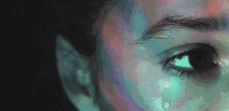a close up of a person 's face with a tear coming out of it .