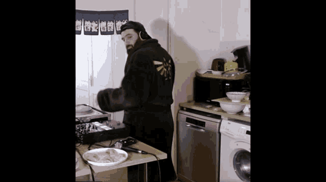 a man wearing a robe with a zelda logo on the back