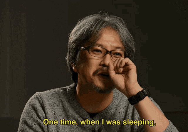 a man with glasses and a beard is laughing and saying i had a random dream