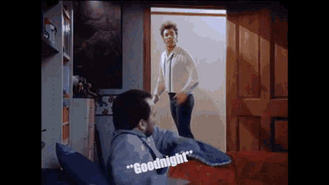 two men are standing in a bedroom and one of them says goodnight