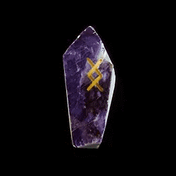 a close up of a crystal with a cross on it .