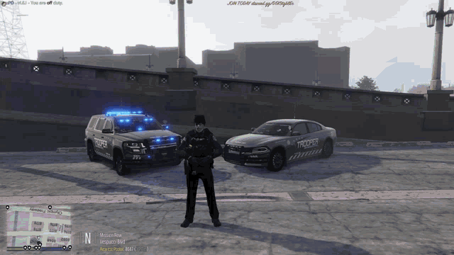 a police officer stands in front of a police car that says trooper