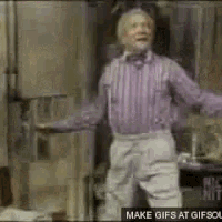 a man in a purple striped shirt is dancing in a room