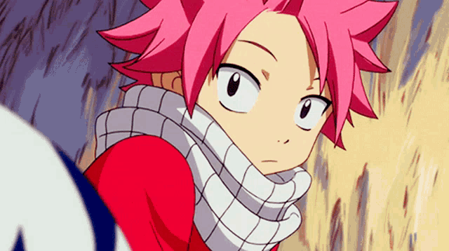 a close up of a person with pink hair wearing a red shirt and a white scarf .