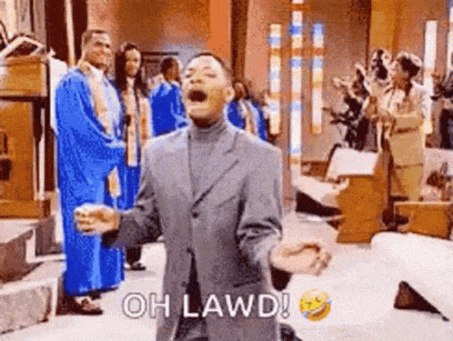 a man in a suit is standing in a church with his arms outstretched and shouting .