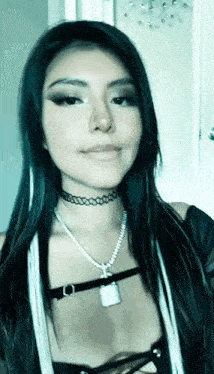 a woman is wearing a choker and a necklace with a padlock on it