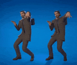 two men in suits are standing next to each other holding a heart .