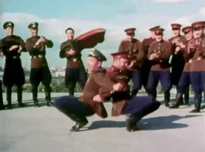 a group of men in military uniforms are dancing on a rooftop