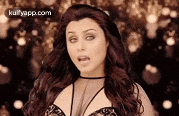 a woman with long hair is making a funny face while standing in front of a crowd .