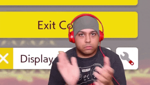 a man wearing red headphones stands in front of a screen that says exit