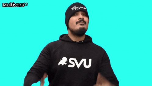 a man giving a thumbs up wearing a shirt that says svu