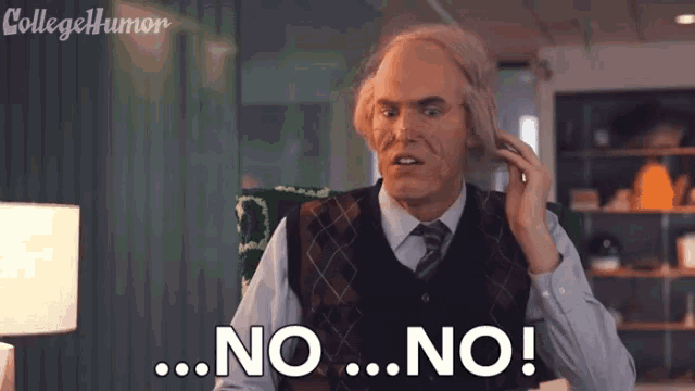 a man with a wig on his head is sitting at a desk and says no .