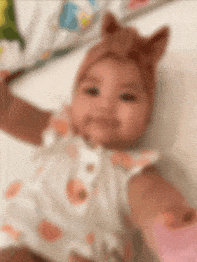 a blurry picture of a baby wearing a headband