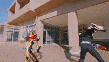 a man in a superhero costume is fighting another man in a superhero costume