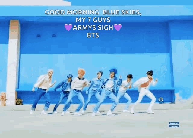 a group of young men are dancing in front of a blue building with the words good morning blue skies my 7 guys