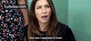 a woman is standing in a staircase talking to another woman and says `` how was i supposed to know '' .