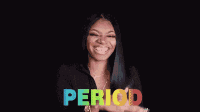 a woman is pointing at the word period in rainbow colors .
