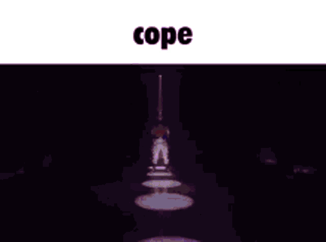 a man in a superhero costume is standing on a stage in front of a crowd and the word cope is above him .