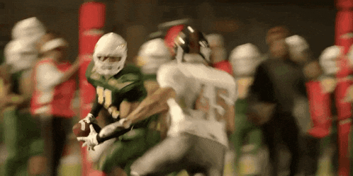 a football player with the number 45 on his jersey is trying to catch the ball
