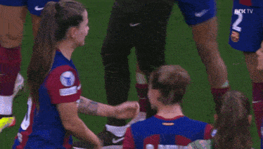 a female soccer player with the number 2 on her shirt