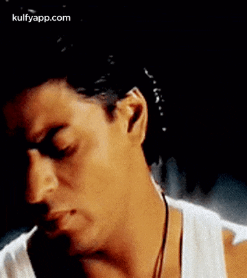 a close up of a man 's face with water coming out of his ears .