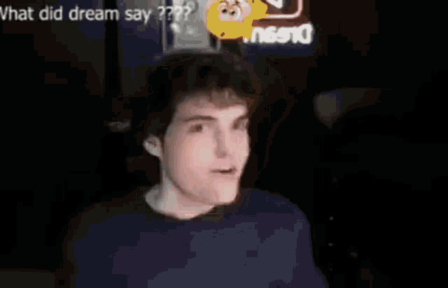 a man is making a funny face in a video with a smiley face .