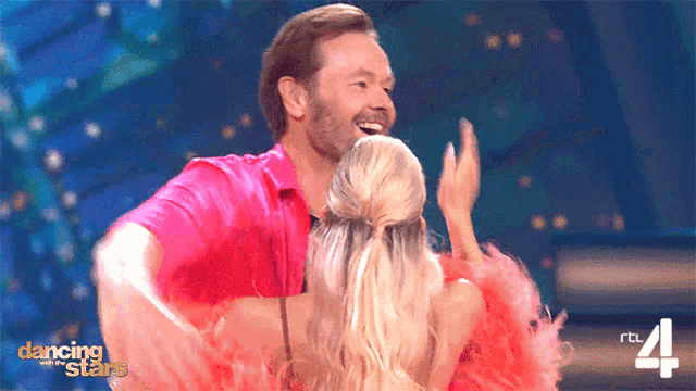 a man and a woman are dancing on dancing stars