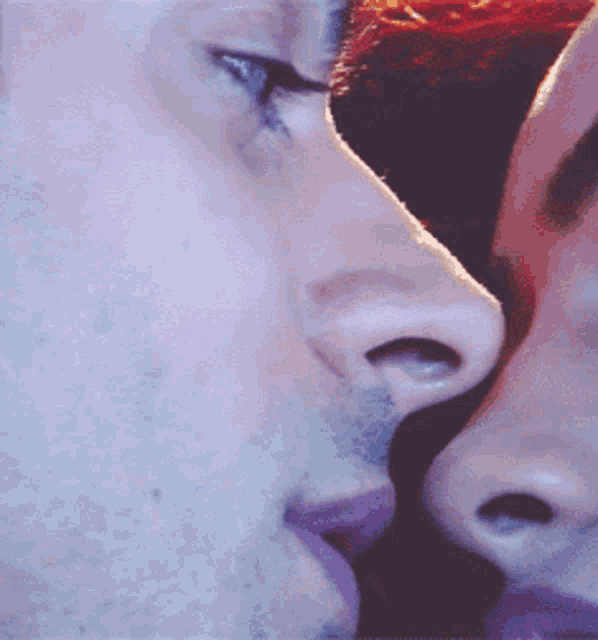 a close up of a man and woman 's faces