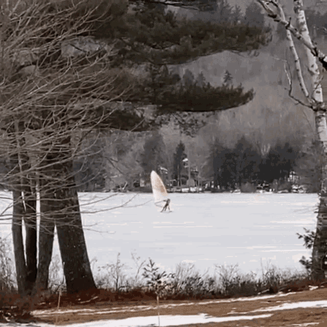 a person is flying over a snowy field