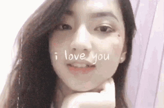 a close up of a woman 's face with the words " i love you " written on it