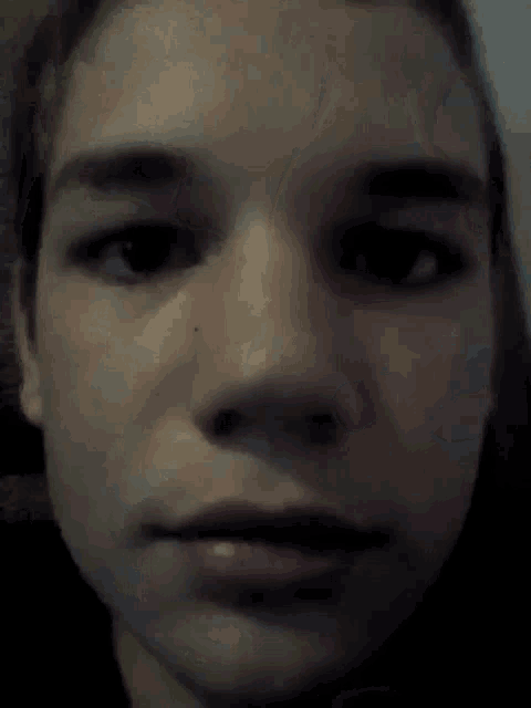 a close up of a person 's face with their mouth open and eyes closed .