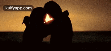 a silhouette of a man and a woman kissing with the website kulfyapp.com visible in the corner