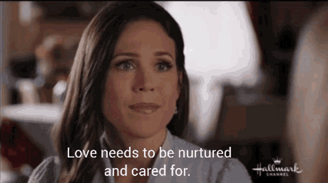 a woman is sitting in front of a sign that says love needs to be nurtured and cared for