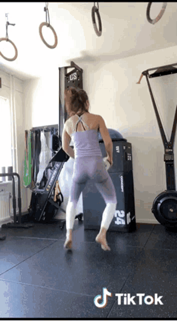 a woman is dancing in a gym with a tiktok watermark