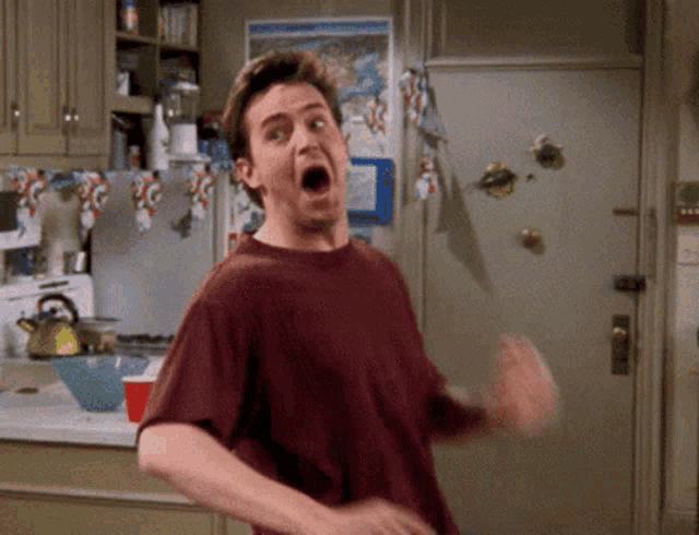 a man is making a funny face in a kitchen