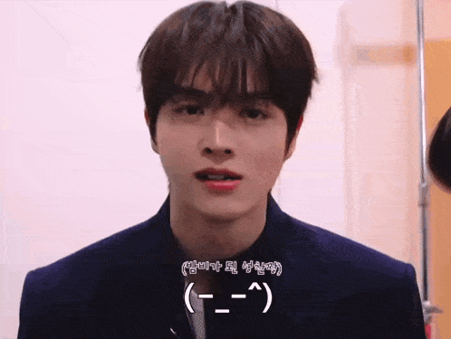 a close up of a young man 's face with korean writing on the bottom