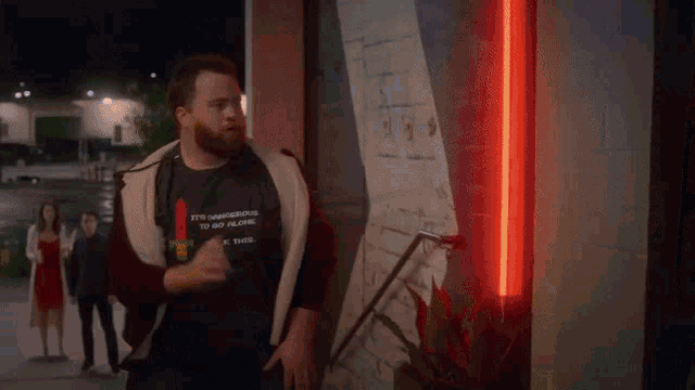 a person is standing in a dark room with a blue light behind them
