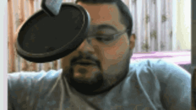 a man with a beard is wearing glasses and a microphone on his face