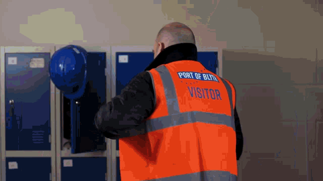 a man wearing a vest that says port of bleith visitor