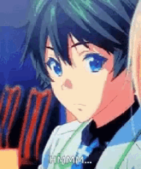 a boy in a suit and tie is sitting next to a girl in a movie theater .