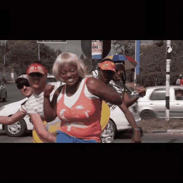 a group of people are dancing in front of a sign that says ' friday june ' on it