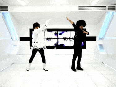 two people are dancing in front of a wall with the words no limit on it