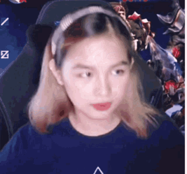 a girl wearing a headband is sitting in a chair .
