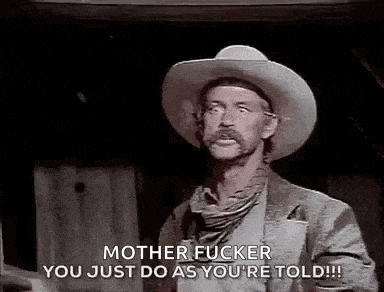 a man in a cowboy hat is talking to another man in a black and white photo .