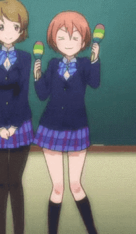 a girl in a school uniform is holding maracas in her hands
