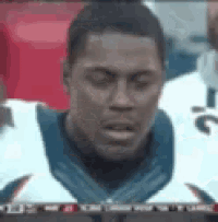 a close up of a man 's face with the number 12 on his jersey