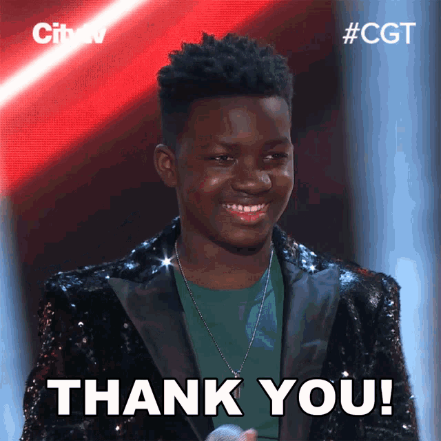 a young man in a sequined suit is smiling and says thank you