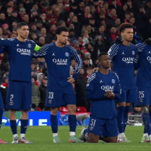 a group of soccer players with qatar written on their jerseys